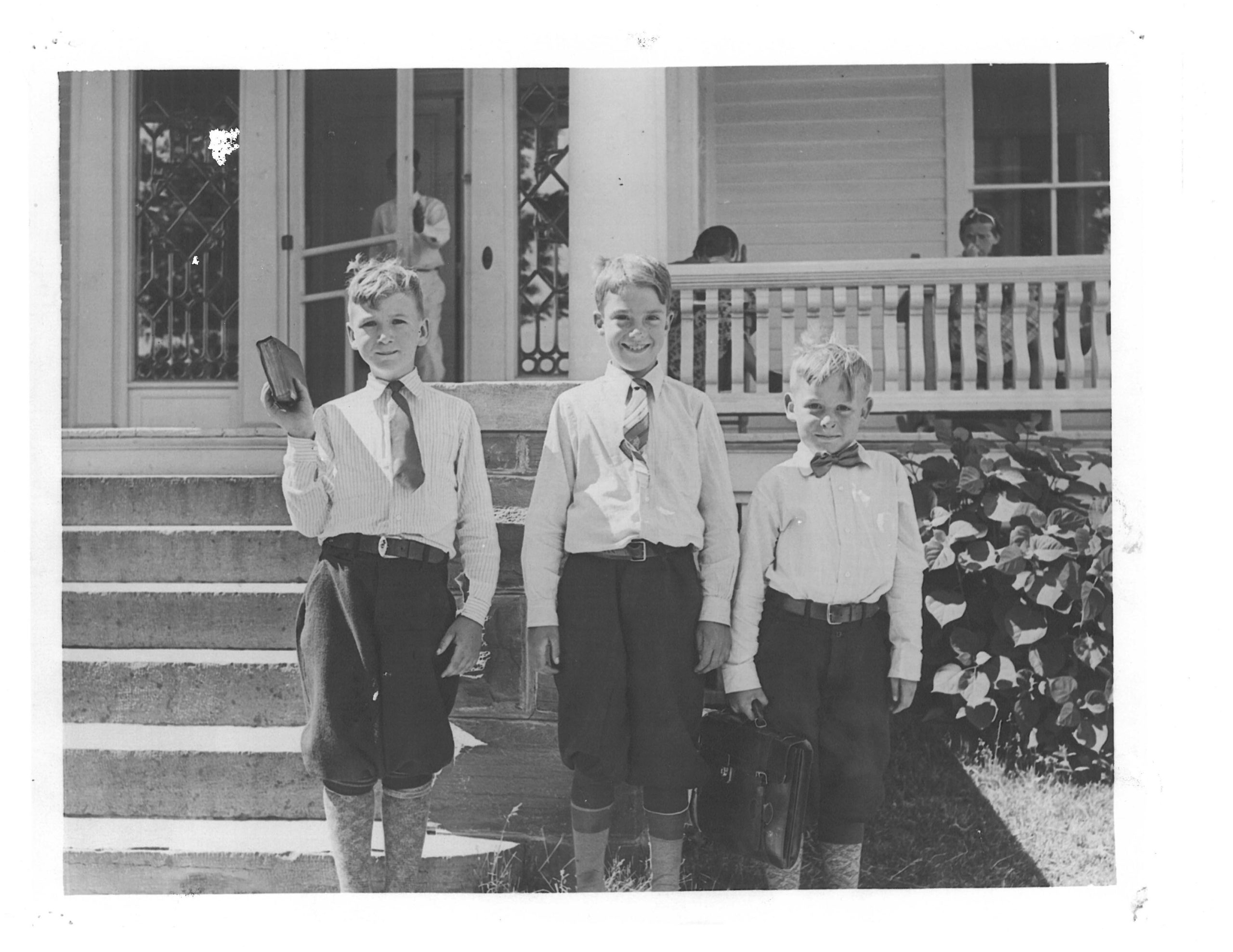 Boys standing in front of the white building